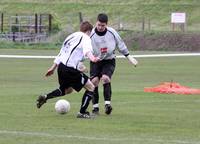 Wells keeper just keeps the Hempnall player out