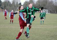 Barratt and the defender watch the ball