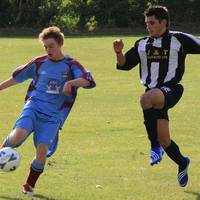 Hempnall defenderJames Daniels clears the ball and