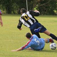 Tackle from manager Oakley wins the ball for Hempn