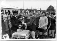 Peter Downing receives the Wortwell Cup from the g