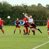 The Loddon keeper, under pressure, punches away