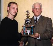 Karl Izzard receiving POY trophy from Club Preside